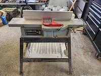 Front view of Delta jointer showing cast iron tables, fence, guard and stand