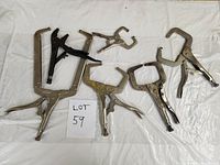 Top-down photo showing eight adjustable vice grip clamps of various sizes and styles arranged on a white sheet with a lot number card 'LOT 59'.