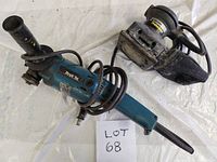 Makita angle grinder and Black & Decker sander side by side on a light surface, both showing signs of use.