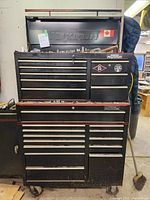 Front view of two-piece black Maximum tool cabinet on casters