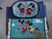 Two Disney floor mats showing both entire pieces placed on the ground.