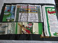 Photo showing 4 of the 5 Irish linen dish towels with colorful prints including Irish blessing and leprechaun.
