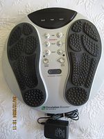 Top view of Circulation Booster CB-V3 device showing footpads, control buttons and branding