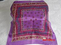 Full view of the purple Liberty silk scarf with visible intricate paisley and floral borders and central motif.