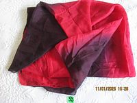 Image showing the scarf partially folded, highlighting the red to black gradient and the fabric texture.