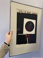 Front view of framed etching "Red and Black IV", showing abstract geometric artwork primarily in black and red with artist signature at bottom.