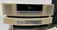 Front view of stacked radio and CD changer with clock display lit