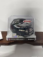 Front view of the Eagles mini helmet with visible Brandon Graham autograph and JSA sticker on case.