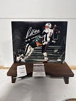 Full view of the signed 11x14 photo of Brandon Graham in Philadelphia Eagles uniform tackling an opponent, showing signature and JSA sticker.