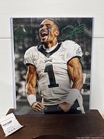 Front view of signed 11x14 Jalen Hurts photo in acrylic sleeve