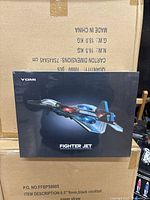 Front view of the YOMI fighter jet drone box showing 3D fighter jet image and branding.