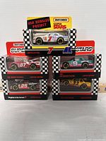 Front view displaying all five Matchbox Superstars limited edition race cars stacked and arranged in original packaging.