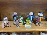 Shelf display showing all four Simpich elf dolls, three Irish collectible figurines, and wax candle mouse.