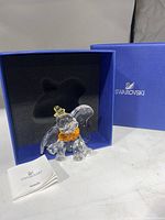 Figurine displayed in original blue Swarovski presentation box with foam insert and booklet