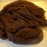 Full view of bunched dark chocolate silk chiffon fabric