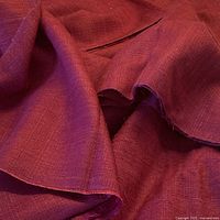 Close view of folded raw silk fabric showing color and texture