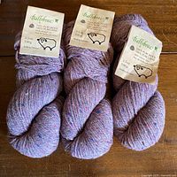 Three skeins of Patons Ballybrae wool yarn on surface