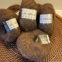 Group of six brown La Gran yarn balls with labels visible