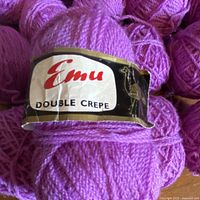 Close-up of Emu Double Crepe yarn ball with label