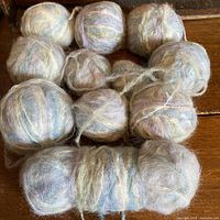Group of nine mohair yarn balls in muted tones