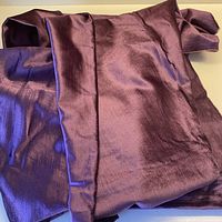 Folded violet-mauve velvet fabric showing sheen and texture