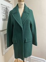 Front view of teal wool blend coat on mannequin