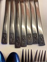 close-up of handle scroll design on utensils