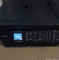 Front panel close-up of Brother MFC-J497DW printer showing LCD display, keypad and control buttons