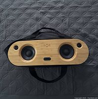 Front view of the Marley Bluetooth speaker showing the bamboo front panel with two speaker drivers and the Marley logo embossed between them.