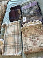 Top view of all items laid out showing duvet cover, pillow shams and two cotton throws with different patterns.