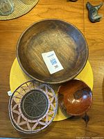 Top view of the three decorative bowls: a large wooden bowl, a medium beaded bowl, and a smaller wooden bowl showing detailed patterns.