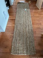 Full view of the entire 2x8 ft runner laid out on wooden floor showing size and pattern.