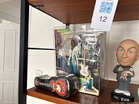 Vintage Jimi Hendrix action figure in original packaging along with guitar accessories and a guitar-shaped case.