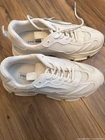 Top view of both white sneakers showing Steve Madden label inside and lace-up design.