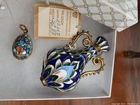 Perfume bottle and charm shown together in box