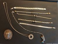 All jewelry pieces laid out on black background