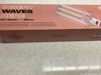 Photo of the hair waver box, showing product name Insert Waves Here, Hair Waver 25mm, color rose gold, and some features like tourmaline ceramic glaze coated hot plates