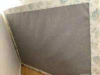 Top view of the box spring showing fabric surface and wooden side frame