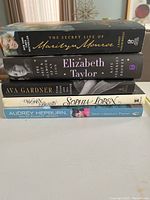 Stack of five hardcover biographies including The Secret Life of Marilyn Monroe, Elizabeth Taylor: The Last Star, Ava Gardner: The Secret Conversations, World Beauty Sophia Loren, and Audrey Hepburn: An Elegant Spirit.