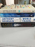 Stack of 4 hardcover books showing spines with titles and authors, photographed to identify and verify contents of lot.