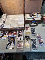 Two open boxes filled with hockey cards including displayed Young Guns cards in front