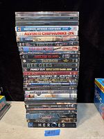 Stack of 20 DVD movies with titles visible on spines