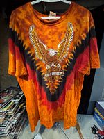 Front view of the Harley Davidson XL T-shirt showing eagle graphic and orange/red/black tie-dye pattern.
