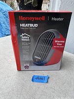 Photo of Honeywell HeatBud personal heater box showing front and details.