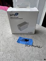 Front view of boxed JUMP USB-C PD 20W fast charging adapter, showing model JP-5016 and 1 year warranty printed.