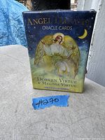 Photo of sealed Angel Dreams Oracle Cards by Doreen Virtue and Melissa Virtue with box artwork showing angel and moon.