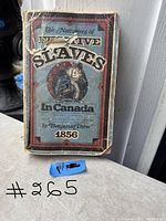 Front cover of the vintage book with visible age wear and creases, showing title, author, and publication year.