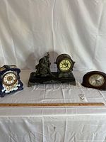 Front view of all three clocks with ruler for scale