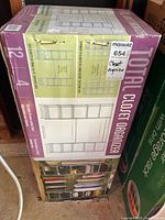 Sealed box front showing Total Closet Organizer product name, graphics and spec labels