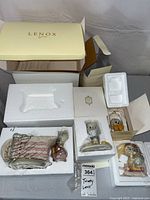 Lenox branded box with Lenox Tweety Bird teapot and three figurines in styrofoam inserts, items wrapped in protective plastic.